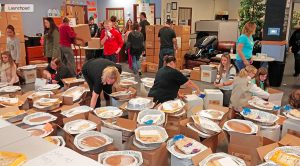 Basket Brigade volunteers assemble some of the estimated 195 meals they prepared for distribution toneeded families last year. The goal this year is500 families. (Basket Brigade of Suburban Chicago photo) 