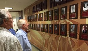 Guests check out the expanded collection of honorees of the revived Elgin High School Alumni Hall of Fame unveiled last week at the school. (Photo by Jack McCarthy / Chronicle Media) 