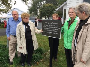  Nancy Beasley (second from left) introduces the plaque commemorating the involvement of DeKalb County citizens in the mid-19th Century Underground Railroad. Below, the unveiling is recorded by some of the 45 persons in attendance at Mayfield Congregational Church. (Photo by Jack McCarthy / Chronicle Media)