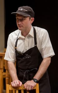 Andrew Jessop plays T.C., manager of the Naperville Caribou Coffee, a dramatic comedy set in the suburb, which is playing at TheaterWit in Chicago. (Photo by Charles Osgood)