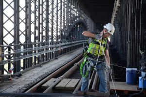 Worker helps renovate the steel structure of historic Eads Bridge. (Photo courtesy of Bi-State Development Agency)