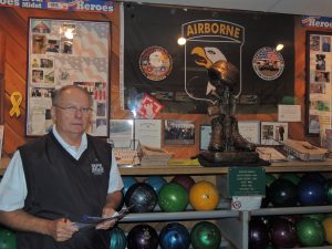John Sommer, owner of Don Carter Lanes pictured at the Veterans Tribute Wall.  (Photo by Lynne Conner/for Chronicle Media)