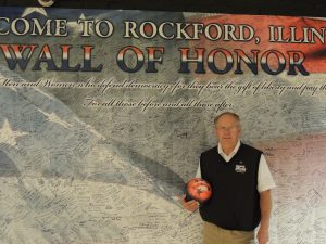 John Sommer, owner of Don Carter Lanes at the Veterans Wall of Honor banner located at the west end of the bowling alley. (Photo by Lynne Conner/for Chronicle Media)