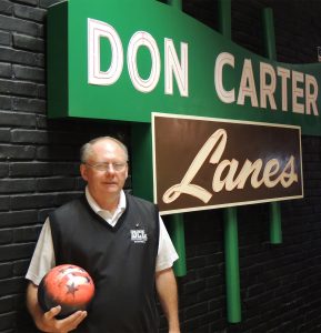 John Sommer, owner of Don Carter Lanes with a replica of the bowling alley's iconic sign. (Photo by Lynne Conner/for Chronicle Media)