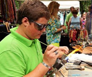 Currently attending Highland Community College, Drew Groezinger says his company produces between 3,000-4,000 glass necklaces a year, 500 glass wine stoppers, and a variety of glass jewelry. (Photo courtesy of National Federation of Independent Business) 