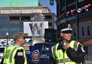 Chicago police officers monitor the area right outside Wrigley Field as the Cubs get ready to parade through the North side with their World Series trophy in tow. (Photo by Karie Angell Luc / for Chronicle Media)