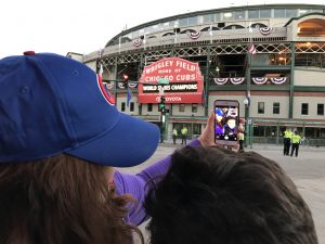Arcenio Rodriguez, 12, a sixth-grader from Chicago with his mother Denise Pfeifer of Chicago. "Seeing the sunrise over Wrigley Field, it's like a new beginning. Hopefully, we'll see many wins in the years to come." "Fly the W!" Arcenio said, riling up the crowd before 7:30 a.m. "I think it's awesome to see the Cubs. This is better than any school field trip." (Photo by Karie Angell Luc/for Chronicle Media)