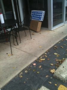 Pro-referendum signs lie in a stack allegedly near the door of Joe’s Place, owned by Westchester Trustee Frank Perry. (Courtesy: Don Mitchell) 