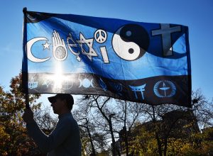 Scott Smith of Oak Park holds a flag on Nov. 12, 2016 in Oak Park at Scoville Park during the Community for Unity Rally by the Suburban Unity Alliance. (Photo by Karie Angell Luc / for Chronicle Media) 