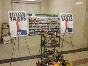 A display by opponents of the Cook County sugary beverage tax show all the drinks that will be included in the tax, which passed last week by the narrowest of margins. (Photo by Kevin Beese/for Chronicle Media) 