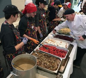 Right, Zach Selch of Evanston, chef/site supervisor, is at the buffet line with volunteers. Images from Nov. 23, 2016 at the Thanksgiving-themed soup kitchen at Beth Emet The Free Synagogue in Evanston, 1224 Dempster St. (Photo by Karie Angell Luc/for Chronicle Media) 