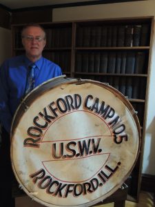 Scott Lewandowski stands with a drum used by Spanish-American War veterans when they marched in parades. (Photo by Lynne Conner/for Chronicle Media)
