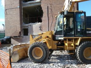 A bobcat is parked in front of one of the underutilized County Jail buildings being razed. (Photo by Kevin Beese/for Chronicle Media) 