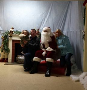 Families waited in line for more than an hour to take pictures with Santa at The Garden Faire during Oswego's annual Christmas Walk on Friday. Dec. 2. 