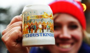 Kate Bleeker, manager of German American Events, is in her element holding the Christkindlmarket Naperville 2016 mug on Dec. 1, 2016 at Christkindlmarket Naperville at Naper Settlement in Naperville, 523 S. Webster St. (Photo by Karie Angell Luc/for Chronicle Media)  